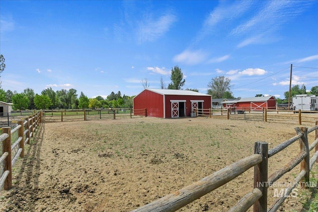 22969 Bumble Bee, Middleton, ID 83644 - view of yard featuring an exterior structure, an outdoor structure, a rural view, and an enclosed riding area