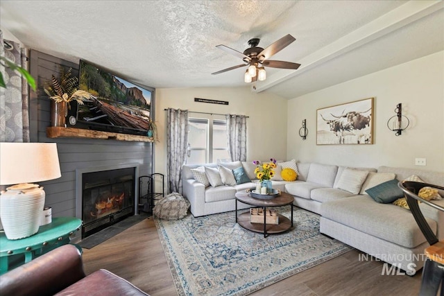 22969 Bumble Bee, Middleton, ID 83644 - living area featuring wood finished floors, a ceiling fan, a fireplace with flush hearth, and a textured ceiling