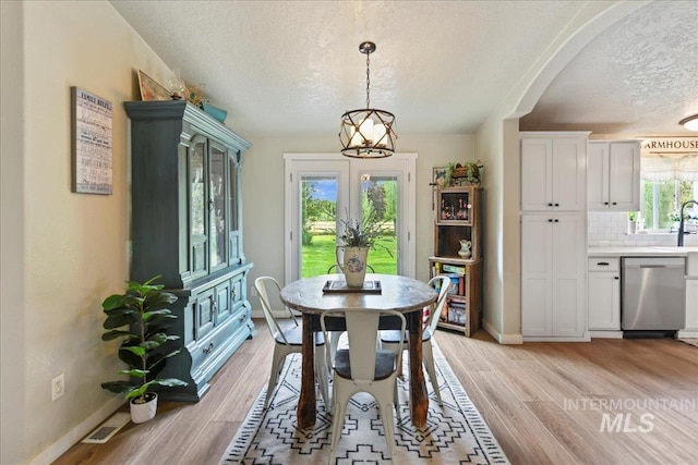 22969 Bumble Bee, Middleton, ID 83644 - dining room with a textured ceiling, light wood finished floors, and baseboards