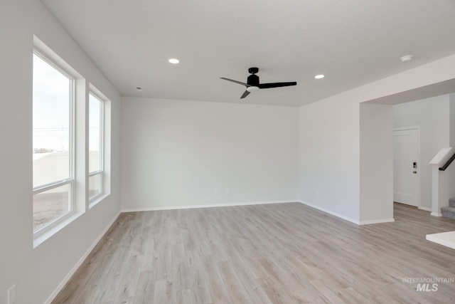 empty room featuring light wood-type flooring and ceiling fan