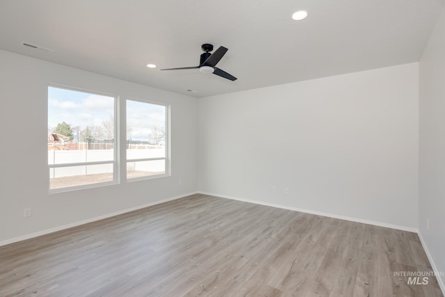 spare room with ceiling fan and light hardwood / wood-style flooring