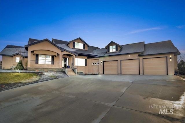 view of front of home with covered porch and a garage