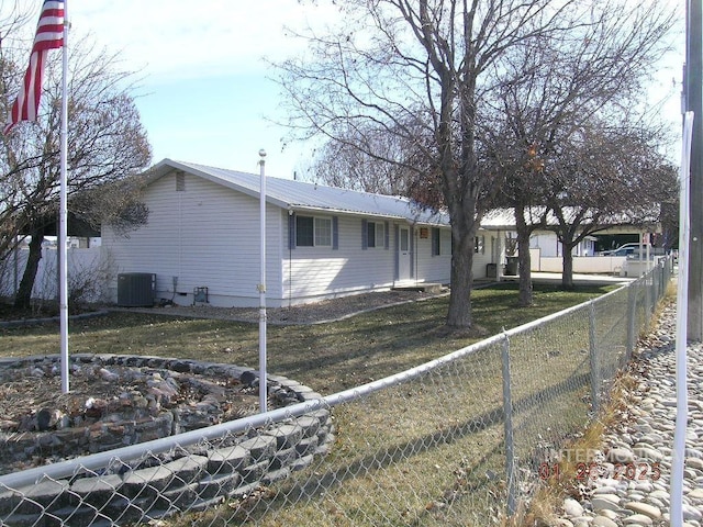 view of home's exterior featuring cooling unit and a lawn