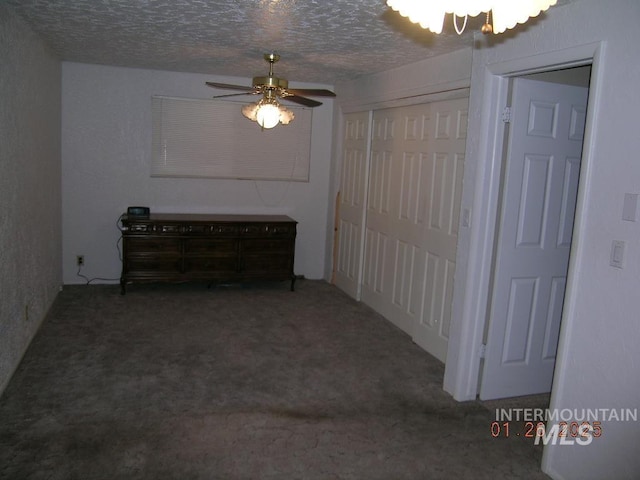 interior space with ceiling fan with notable chandelier and a textured ceiling