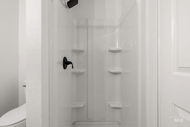 full bathroom with toilet and a shower