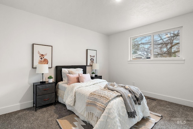 bedroom featuring dark colored carpet and baseboards