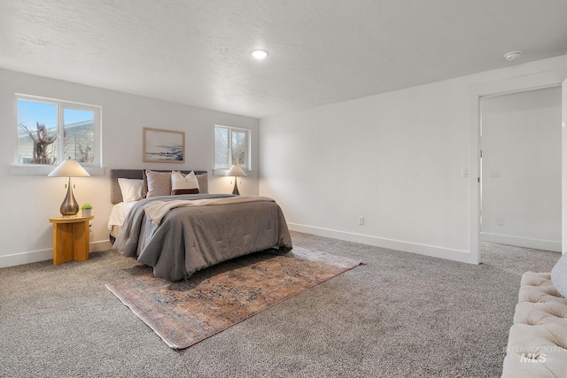 bedroom with carpet flooring, a textured ceiling, and baseboards