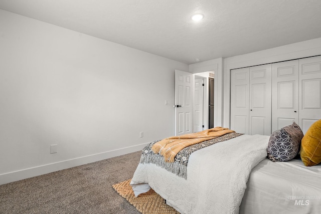 bedroom with a closet, baseboards, and carpet