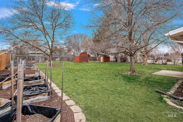 view of yard featuring a storage shed, a fenced backyard, and an outdoor structure