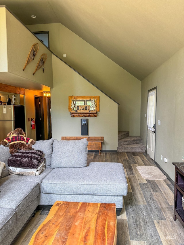 living room with wood-type flooring and vaulted ceiling