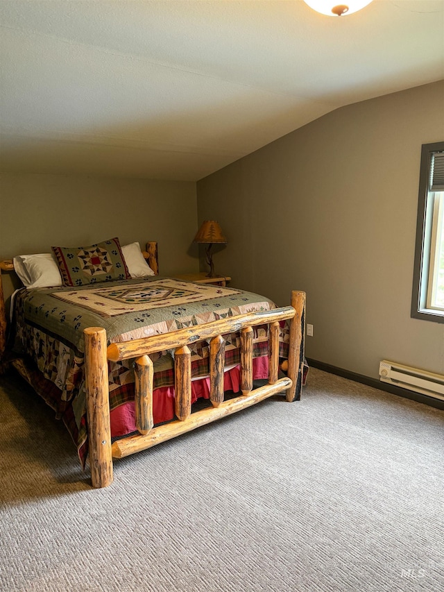 carpeted bedroom with baseboard heating and vaulted ceiling