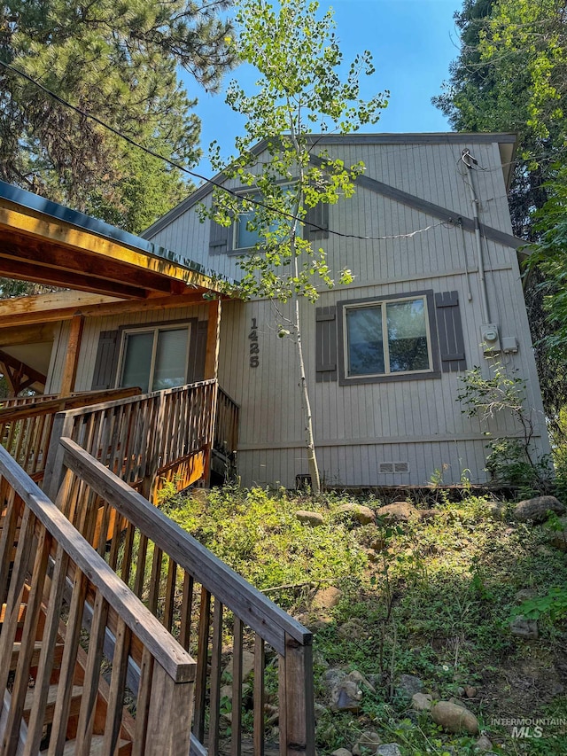 view of side of home with a deck