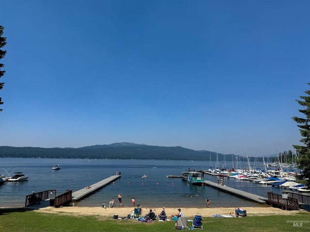 water view with a boat dock and a mountain view