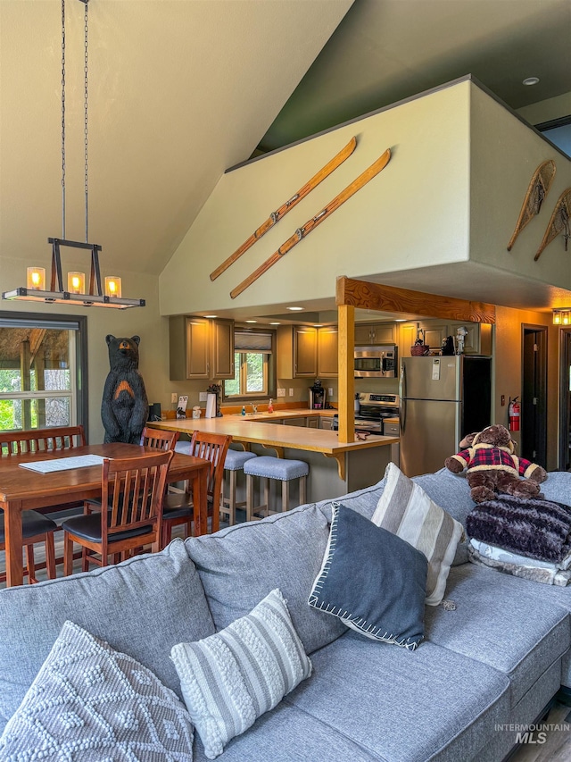 living room with vaulted ceiling, sink, and an inviting chandelier