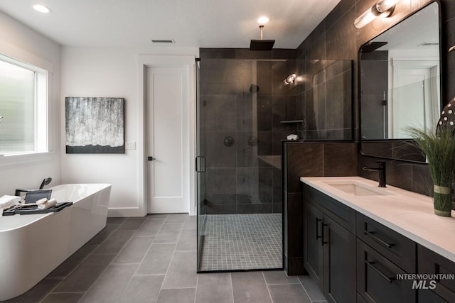 7755 W Flathead Lake St, Eagle, ID 83616 - bathroom with a shower stall, a freestanding bath, double vanity, tile patterned flooring, and recessed lighting
