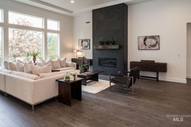 7755 W Flathead Lake St, Eagle, ID 83616 - living room with dark wood-type flooring, recessed lighting, a tile fireplace, and baseboards