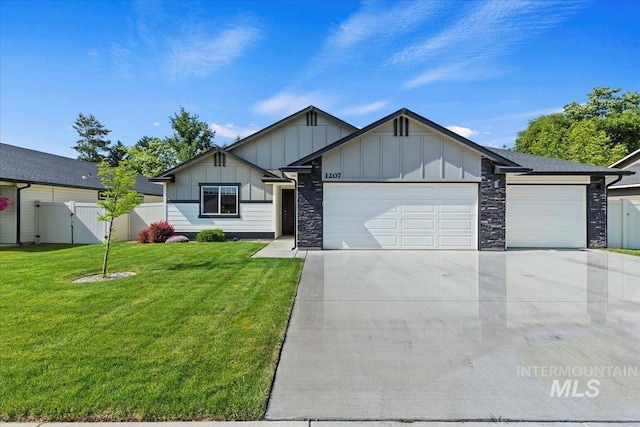 1207 Cottonwood Dr, Fruitland, ID 83619 - ranch-style home with board and batten siding, a garage, concrete driveway, stone siding, and a gate
