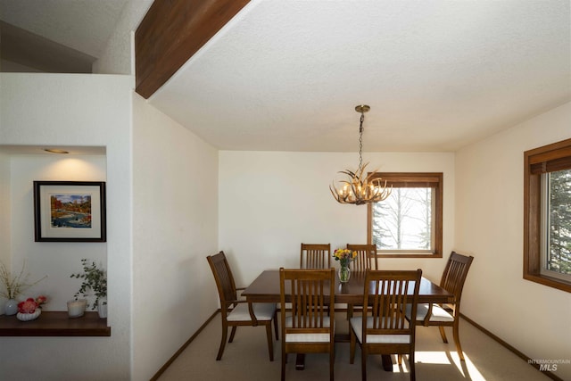 732 Morning Star Rd, Sun Valley, ID 83353 - dining room with carpet, an inviting chandelier, a healthy amount of sunlight, and baseboards