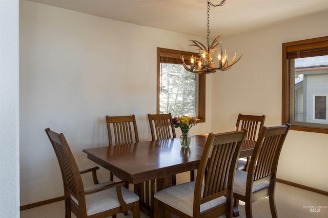 732 Morning Star Rd, Sun Valley, ID 83353 - dining space with a notable chandelier, baseboards, and carpet floors