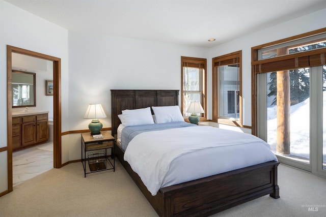 732 Morning Star Rd, Sun Valley, ID 83353 - bedroom featuring baseboards, a sink, access to exterior, ensuite bathroom, and light colored carpet