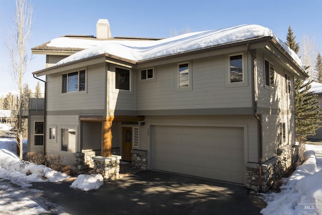 732 Morning Star Rd, Sun Valley, ID 83353 - view of front of property with stone siding, an attached garage, a chimney, and driveway