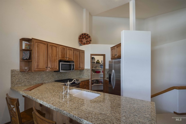 732 Morning Star Rd, Sun Valley, ID 83353 - kitchen with light stone countertops, open shelves, a sink, stainless steel appliances, and tasteful backsplash