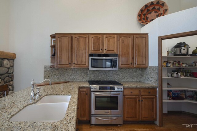 732 Morning Star Rd, Sun Valley, ID 83353 - kitchen with tasteful backsplash, a sink, light stone countertops, stainless steel appliances, and open shelves