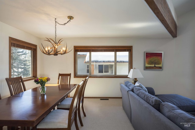 732 Morning Star Rd, Sun Valley, ID 83353 - carpeted dining room featuring beam ceiling, a notable chandelier, baseboards, and a wealth of natural light