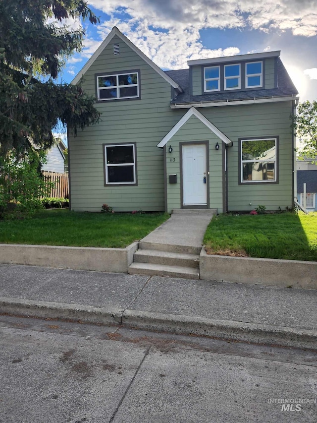 view of front facade with fence and a front lawn