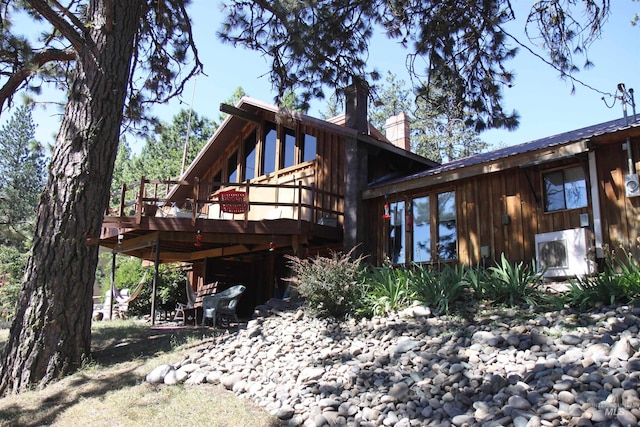 rear view of house featuring a deck