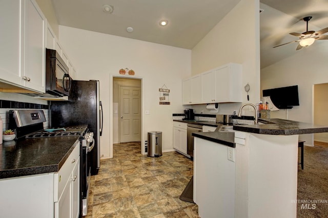 kitchen with kitchen peninsula, a breakfast bar, white cabinets, vaulted ceiling, and appliances with stainless steel finishes