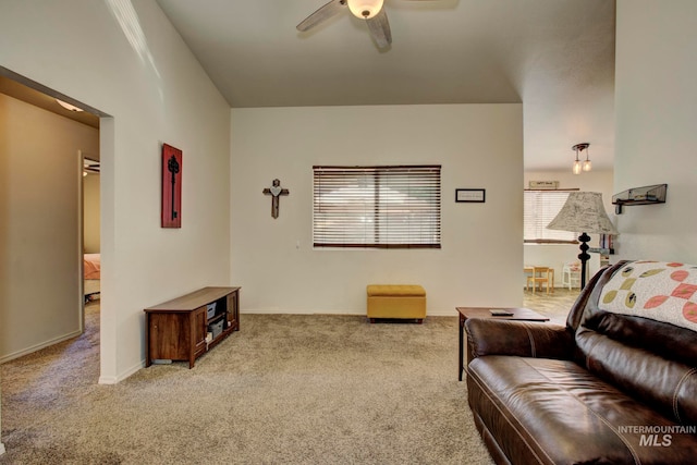 carpeted living room featuring ceiling fan