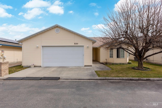 ranch-style home with a front lawn, an attached garage, and concrete driveway