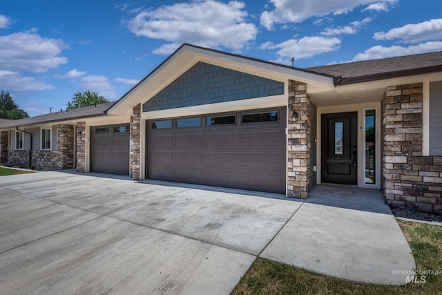 3438 5th St Unit D, Lewiston, ID 83501 - view of front of property featuring a garage, stone siding, and concrete driveway
