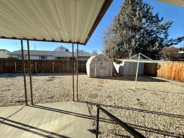 view of yard with a storage unit and a patio