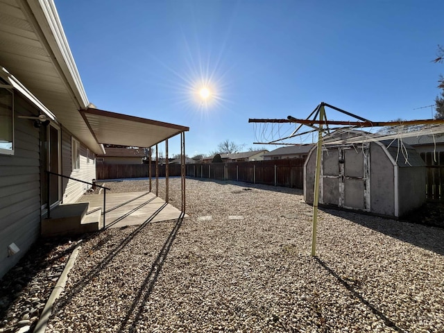 view of yard with a storage unit and a patio area