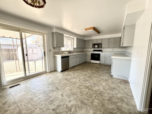 kitchen with sink, appliances with stainless steel finishes, and gray cabinets