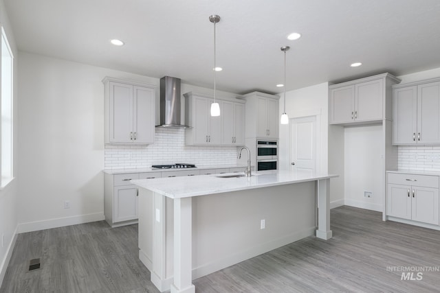 1189 W Grassland St, Middleton, ID 83644 - kitchen with wall chimney range hood, a sink, tasteful backsplash, light wood-style floors, and recessed lighting