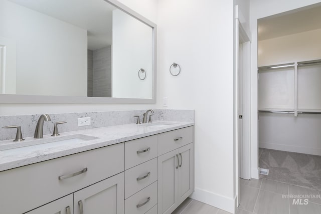 1189 W Grassland St, Middleton, ID 83644 - bathroom featuring double vanity, tile patterned floors, and baseboards