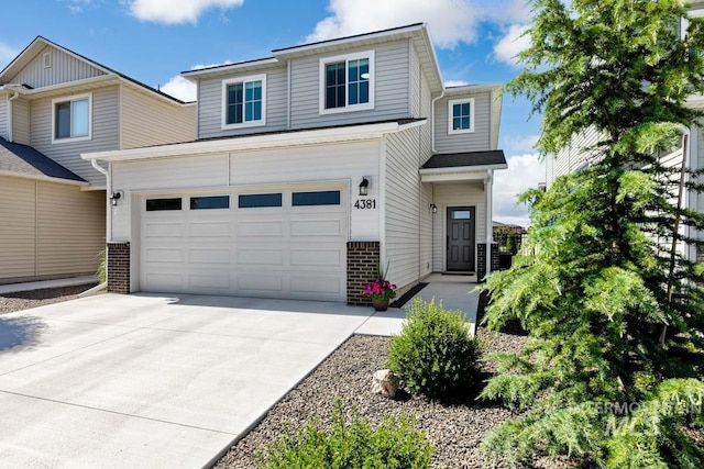4381 E Sportivo Dr, Boise, ID 83642 - view of front of home with driveway, brick siding, and an attached garage