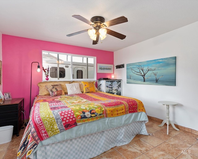 tiled bedroom featuring baseboards and ceiling fan