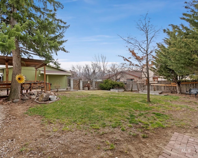 view of yard featuring a fenced backyard and a gate