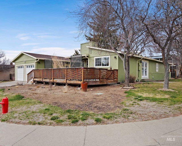 view of front of house with a wooden deck, french doors, a garage, and a chimney