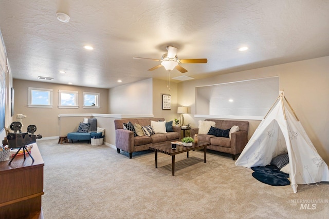 living room featuring light colored carpet and ceiling fan