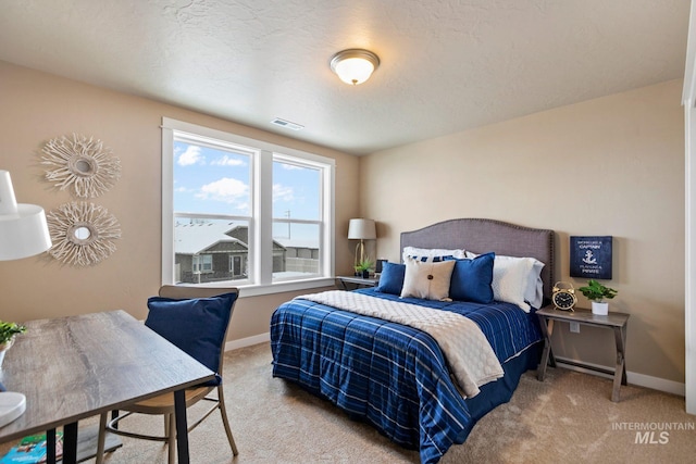 carpeted bedroom with a textured ceiling