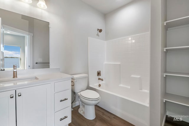 full bathroom with toilet, hardwood / wood-style floors, vanity, and bathing tub / shower combination