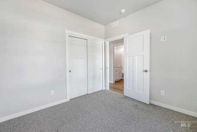 unfurnished bedroom with carpet floors and a closet