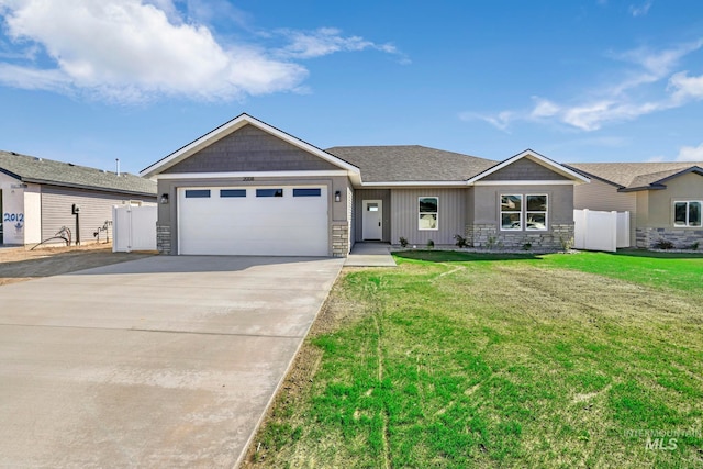 ranch-style house featuring a garage and a front lawn