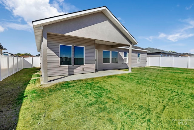 back of property featuring a yard and a patio area