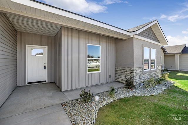 entrance to property featuring a lawn